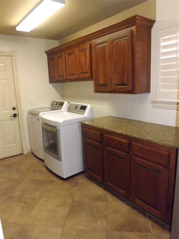 laundry room with cabinets and washing machine and clothes dryer