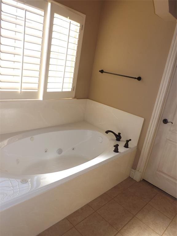 bathroom featuring tile patterned floors and a bathtub