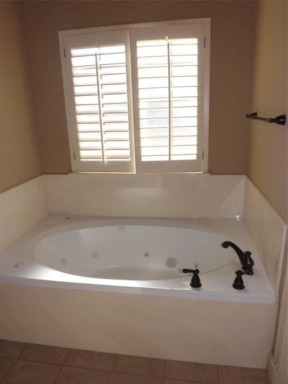 bathroom featuring tile patterned flooring and a bathtub