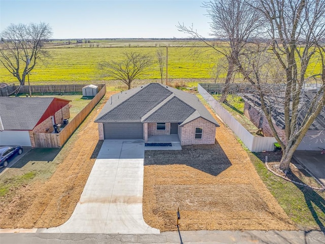 birds eye view of property with a rural view