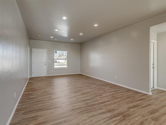 spare room featuring light hardwood / wood-style flooring