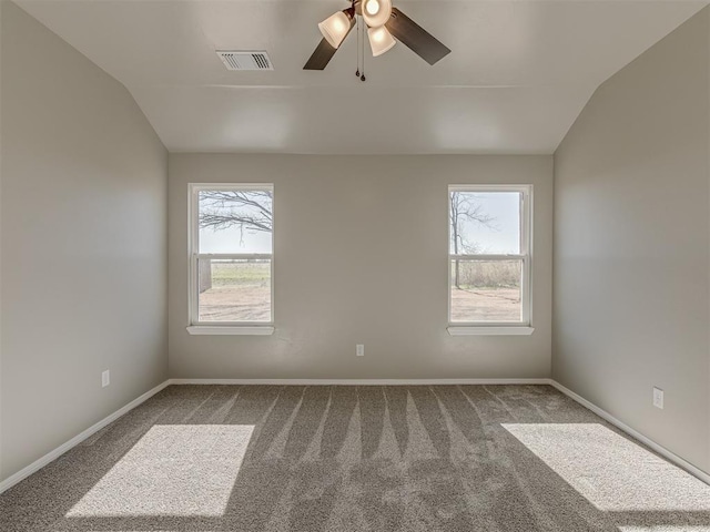 spare room with ceiling fan, carpet floors, and vaulted ceiling