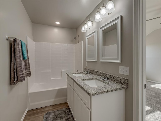 bathroom with vanity, hardwood / wood-style floors, and  shower combination