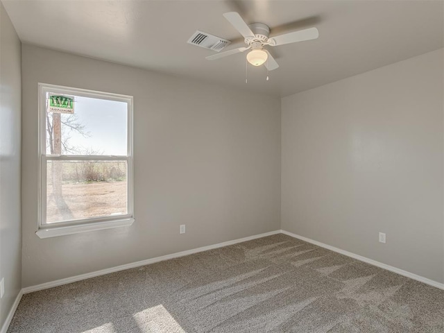 empty room featuring carpet flooring and ceiling fan