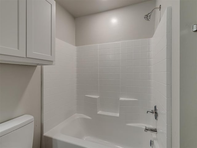 bathroom with washtub / shower combination and toilet