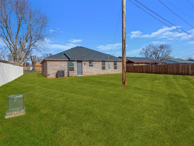502 E Hudson St, Lexington, OK 73051 - back of house featuring brick siding, a shingled roof, and central air condition unit