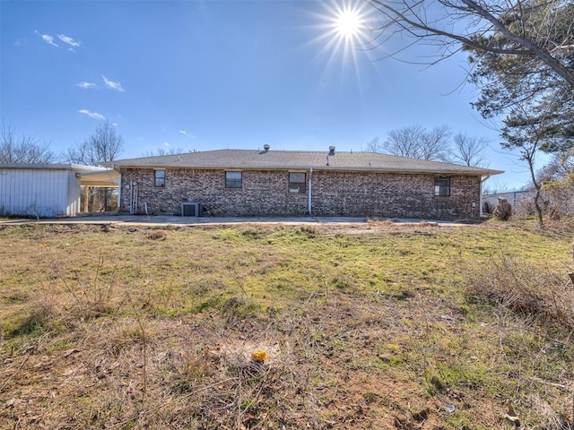 back of property featuring cooling unit, a patio, and a lawn