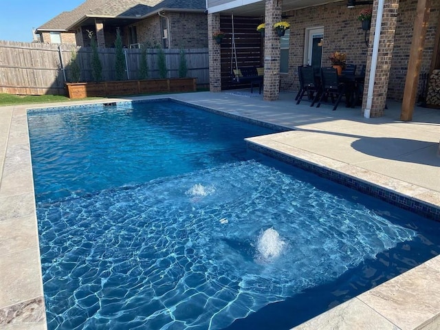 view of swimming pool with a patio