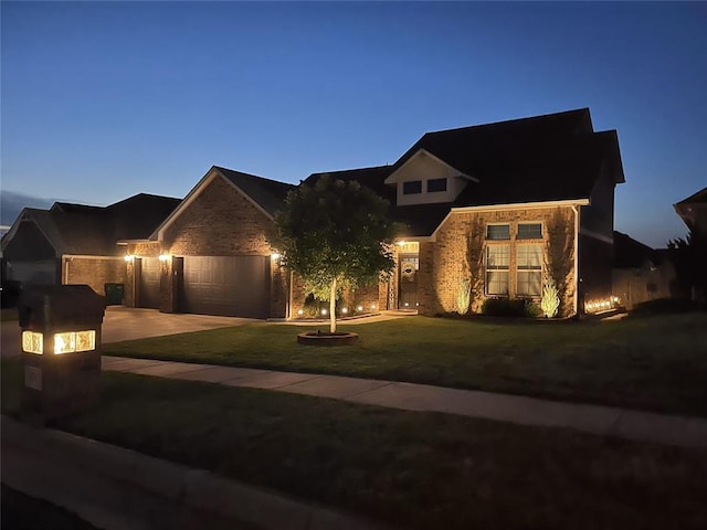 view of front of house featuring a garage and a yard