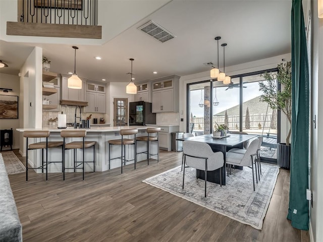 dining space with wood-type flooring