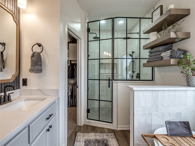 bathroom with vanity, hardwood / wood-style flooring, and walk in shower