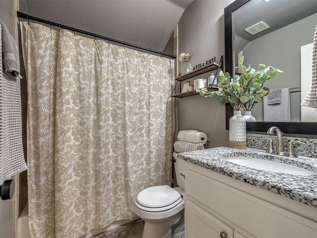 bathroom with vanity, lofted ceiling, walk in shower, and toilet