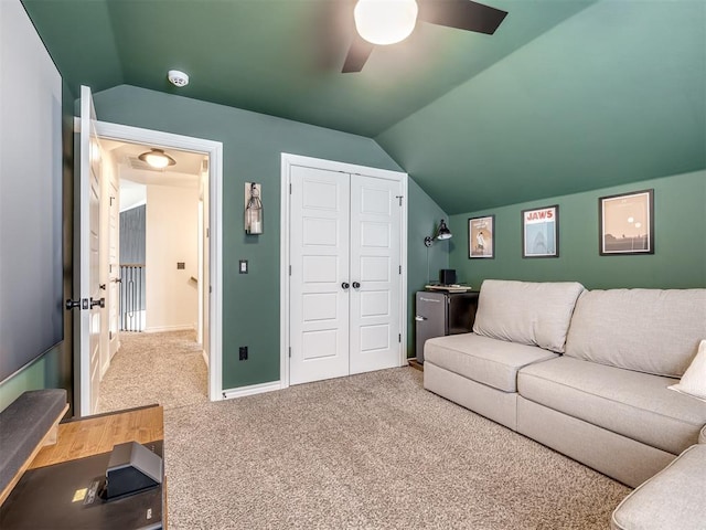 living room featuring lofted ceiling, carpet floors, and ceiling fan