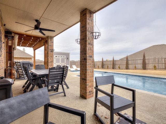 view of patio with a fenced in pool and ceiling fan