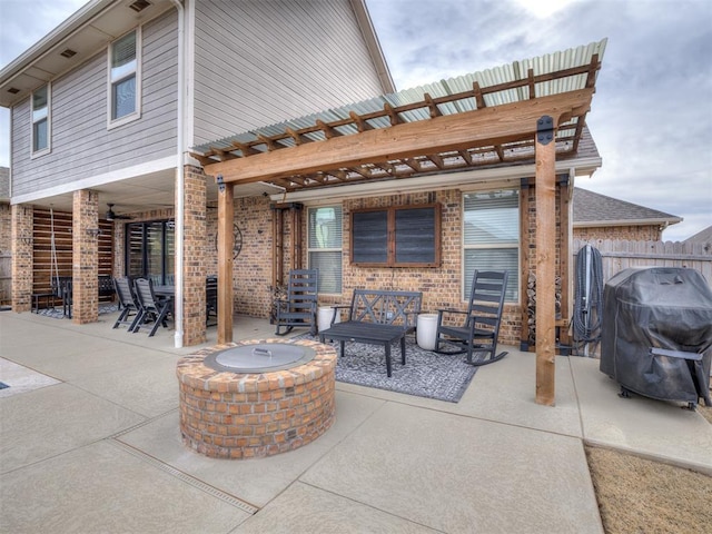 view of patio / terrace with a grill and a fire pit