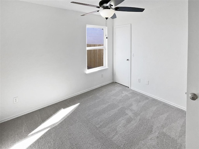 unfurnished room with light colored carpet and ceiling fan