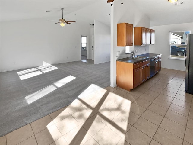 kitchen featuring ceiling fan, sink, light carpet, and stainless steel refrigerator