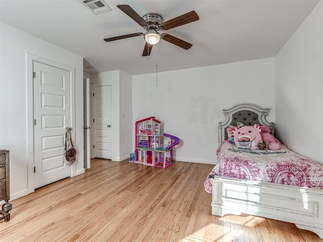 bedroom with ceiling fan and light wood-type flooring