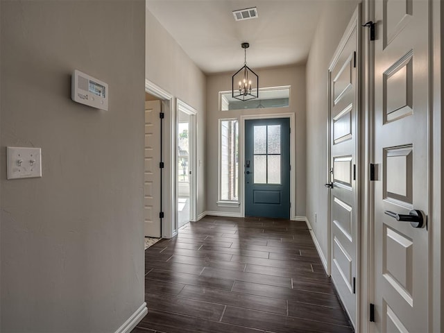 foyer entrance featuring an inviting chandelier