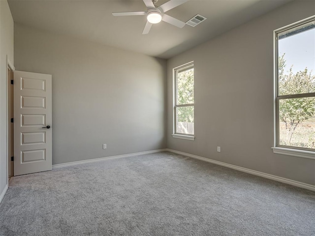 spare room with light carpet and ceiling fan