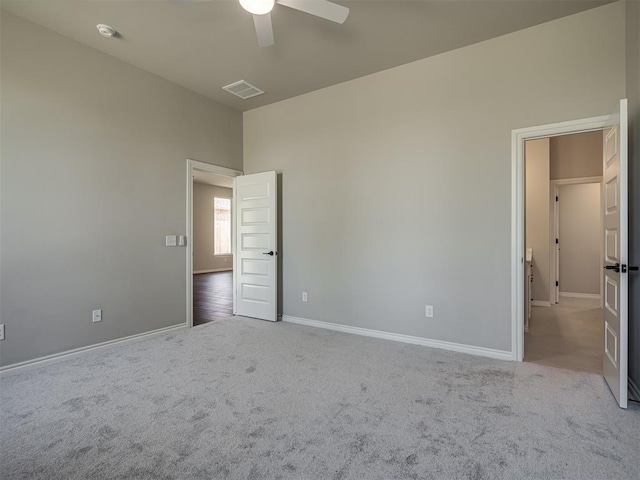 unfurnished bedroom with ceiling fan and light carpet