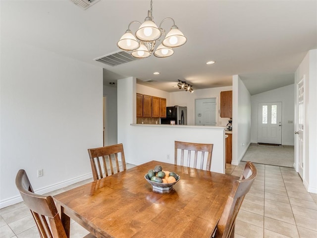 dining space featuring an inviting chandelier, vaulted ceiling, and light tile patterned floors