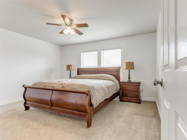 bedroom with ceiling fan and light carpet