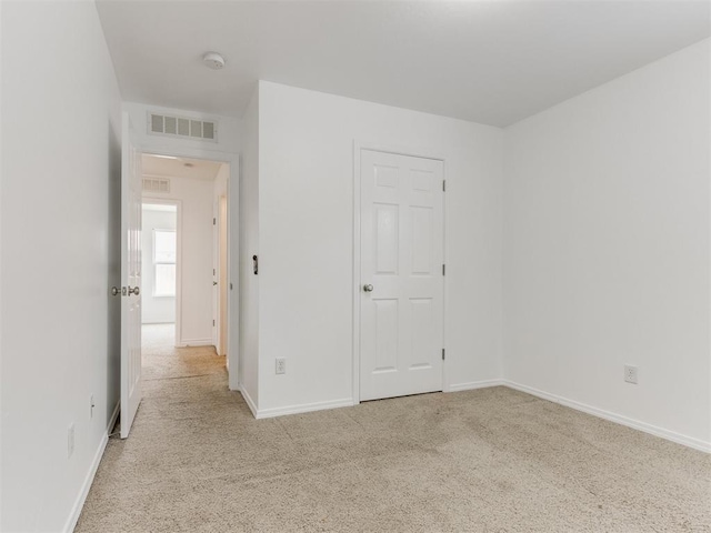 spare room with light carpet