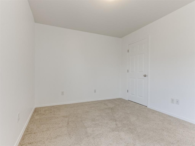 empty room featuring light carpet