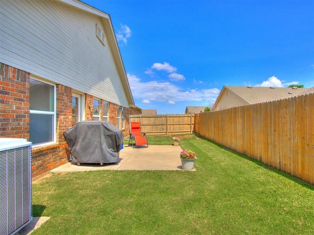 view of yard featuring cooling unit and a patio area