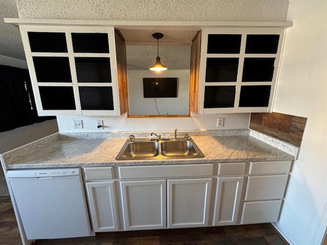 kitchen with decorative light fixtures, sink, white cabinets, white dishwasher, and light stone countertops