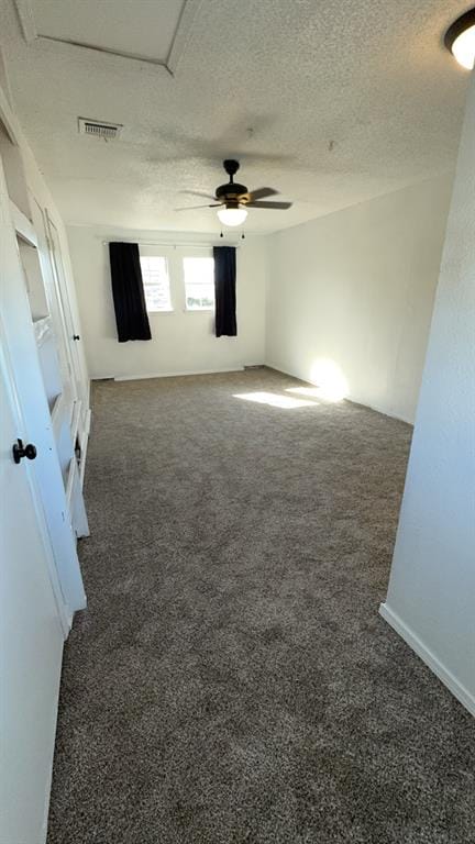 carpeted empty room featuring a textured ceiling and ceiling fan