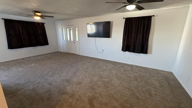 carpeted empty room with ceiling fan and a textured ceiling