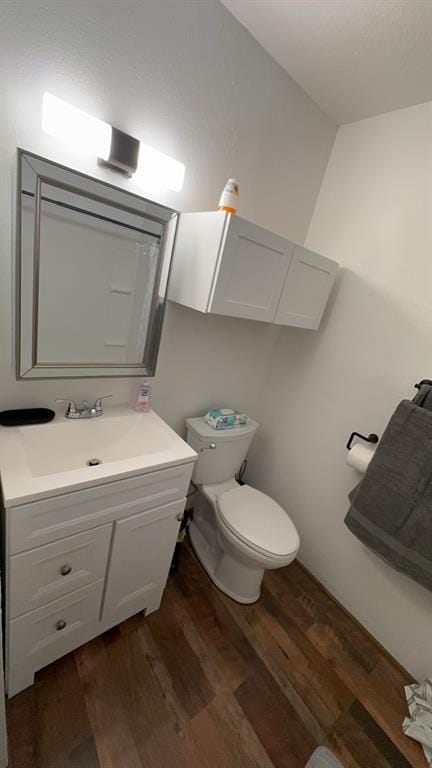 bathroom with vanity, hardwood / wood-style floors, and toilet