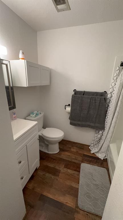 bathroom featuring vanity, hardwood / wood-style flooring, and toilet