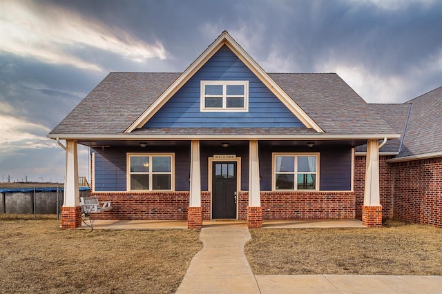 craftsman inspired home with a porch and a front lawn