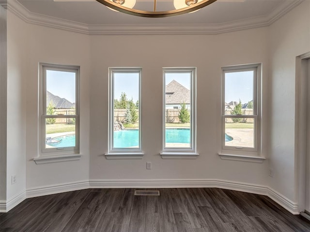 empty room with crown molding and dark hardwood / wood-style flooring