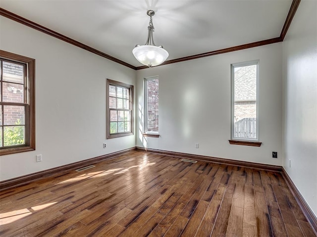 unfurnished room with hardwood / wood-style flooring, ornamental molding, and plenty of natural light