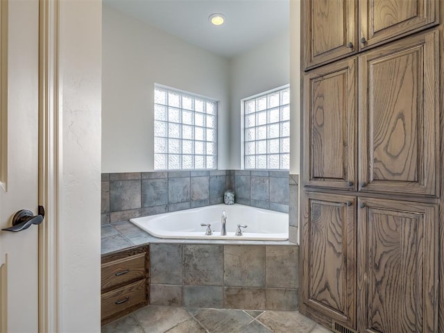 bathroom with tiled tub