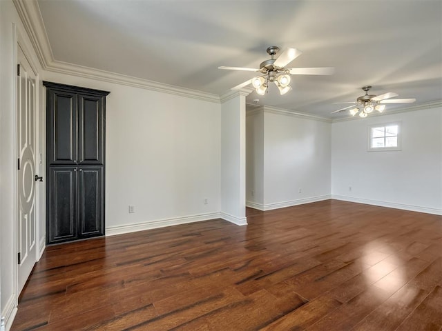 unfurnished room featuring crown molding, dark wood-type flooring, and ceiling fan