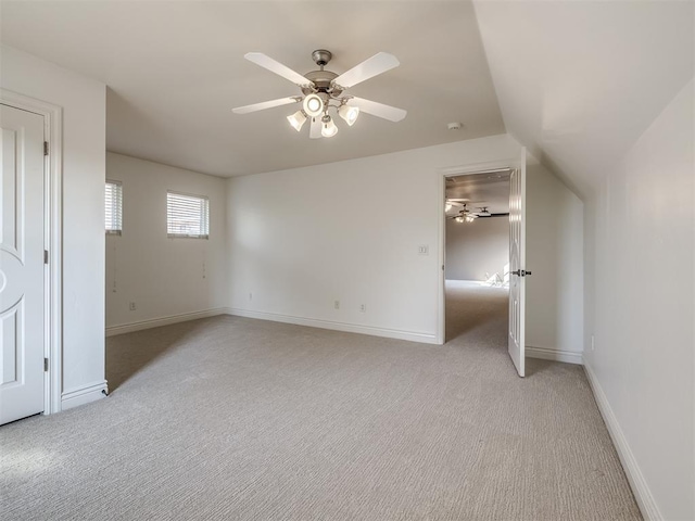 unfurnished bedroom featuring lofted ceiling, light carpet, and ceiling fan