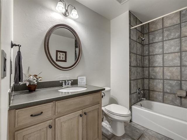 full bathroom with tiled shower / bath combo, vanity, tile patterned flooring, and toilet