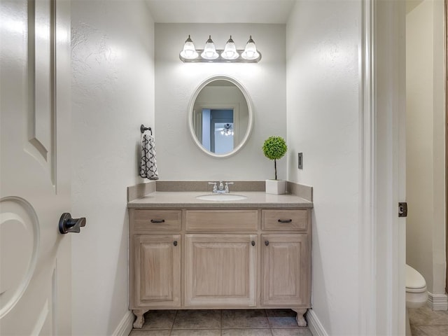 bathroom featuring vanity, tile patterned floors, and toilet