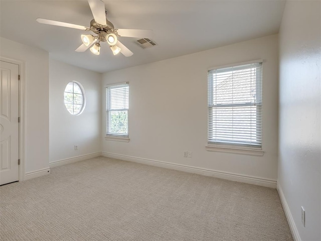 empty room featuring light carpet and ceiling fan