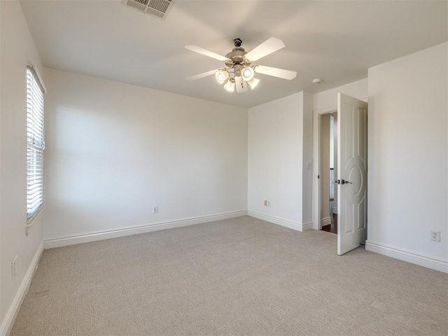 carpeted empty room featuring ceiling fan