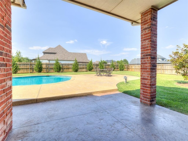 view of pool featuring a patio and a lawn