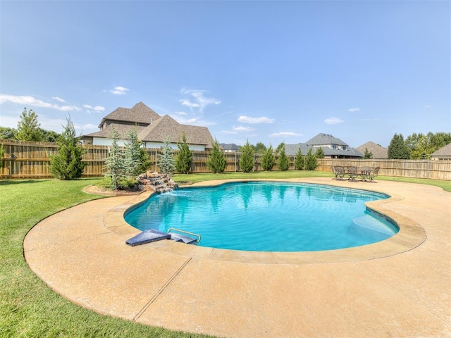 view of swimming pool with a yard and a patio