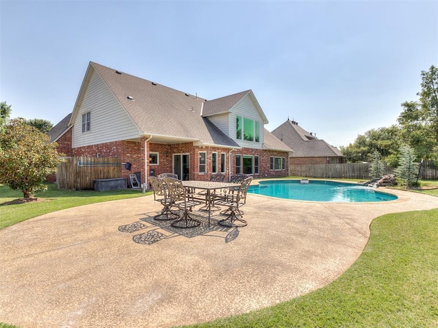 view of swimming pool with a diving board, a patio area, and a lawn