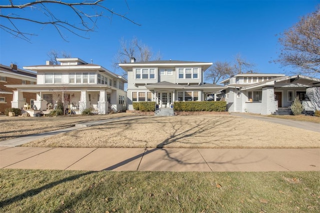 view of front facade featuring covered porch and a front yard