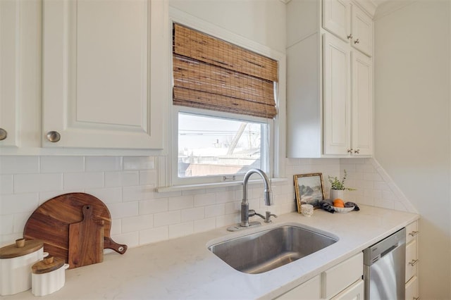 kitchen with white cabinetry, sink, and dishwasher